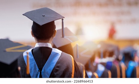 Rear view of university graduates wearing graduation gown and cap in the commencement day - Shutterstock ID 2268966413