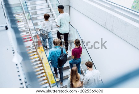 Similar – Foto Bild Rückansicht einer Frau mit rotem Hut, kurzer Jeans, Bluse und gemusterten Strümpfen steht auf einem großen Platz mit gemustertem Belag