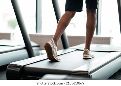 Rear View Of Unrecognizable Black Male Legs Jogging On Treadmill In Gym, Young African American Man Running On Path In Modern Fitness Club, Healthy Lifestyle And Sport Trainings Concept, Cropped