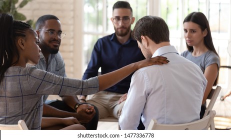 Rear view at upset man feel pain depression problem addiction get psychological support of counselor therapist coach diverse people friend group help patient during therapy counseling session concept - Shutterstock ID 1477336778