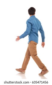 Rear View Of A Walking Casual Man Looking To Side On White Background