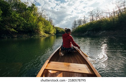 Rear view of woman enjoy spring canoe ride