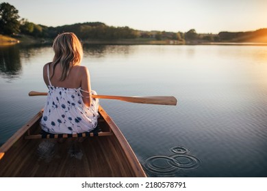 Rear view of woman enjoy summer canoe ride
