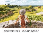 Rear view of woman looking at green vineyard in Bordeaux region, Saint Emilion- France, Nouvelle aquitaine