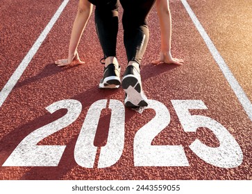 Rear view of a woman preparing to start on an athletics track engraved with the year 2025 - Powered by Shutterstock