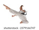 Rear view. Woman professional karate fighter jumping and performing kick in action isolated over white background. Concept of sport, recreation, art, hobby, culture. Copy space for ad, text.