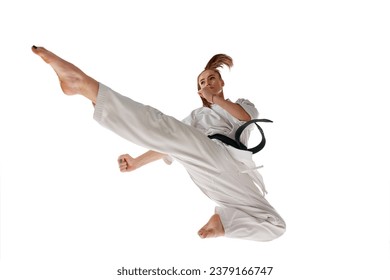 Rear view. Woman professional karate fighter jumping and performing kick in action isolated over white background. Concept of sport, recreation, art, hobby, culture. Copy space for ad, text. - Powered by Shutterstock