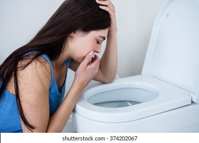 Rear View Of Woman Throwing Up In Toilet