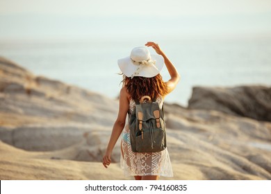 Rear View Of A Woman Walking On The Beach