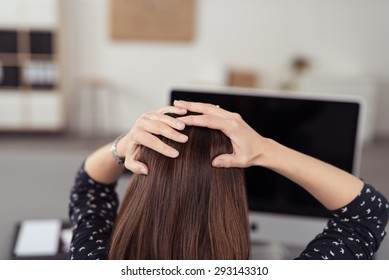 Rear View Of A Worried Office Woman Holding Her Head In Front Her Powered Off Computer Due To Power Interruptions.