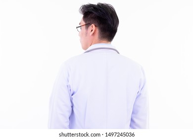 Rear view of young Asian man doctor looking over shoulder