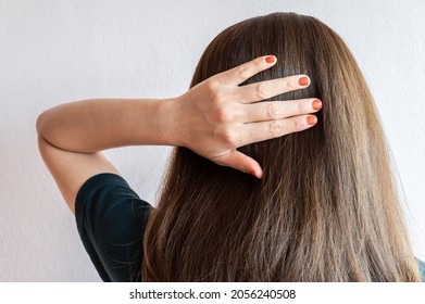 Rear View Of Young Asian Woman Touching Her Thick Hair. Thick Hair Technically Refers To The Width Of A Single Strand Of Hair, Whereas Hair Density Refers To The Number Of Strands On Your Head.