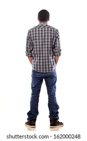 rear view of young black man with his hands in his pockets