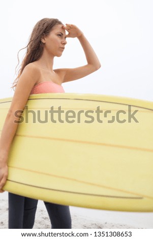 Similar – Young surfer woman with top and bikini holding surfboard