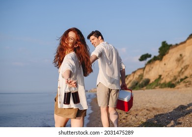 Rear View Young Couple Friend Family Man Woman In White Clothes Show Beer Bottle Picnic Bag Refrigerator Hold Hands Walk Rest Together At Sunrise Over Sea Beach Outdoor Seaside In Summer Day Sunset