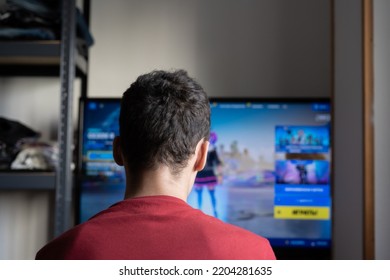 Rear View Of A Young Guy Gamer Playing Games