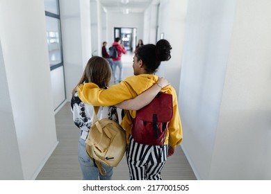 Rear view of young high school students walking in corridor at school, back to school concept. - Powered by Shutterstock