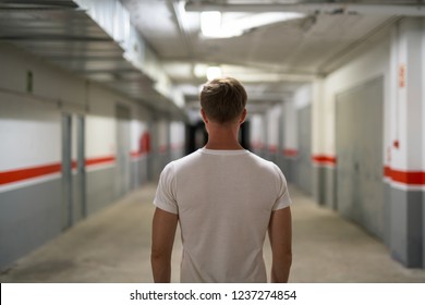 Rear View Of Young Man In The Corridor Of Storage Warehouse