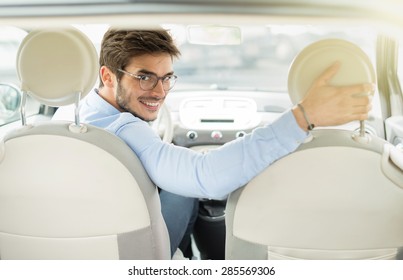 Rear View, Young Man Driving His Car, Looking At Camera