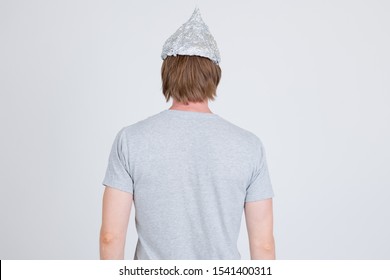 Rear View Of Young Man With Tinfoil Hat As Conspiracy Theory Concept