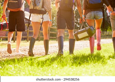 Rear View Of Young People Going Camping At Music Festival - Powered by Shutterstock