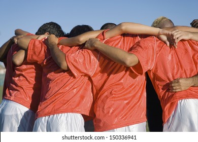 Rear view of young soccer players discussing strategy - Shutterstock ID 150336941
