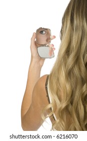 Rear View Of Young Woman Holding Up Makeup Compact. Reflection Of Her Eye Visible In Mirror.