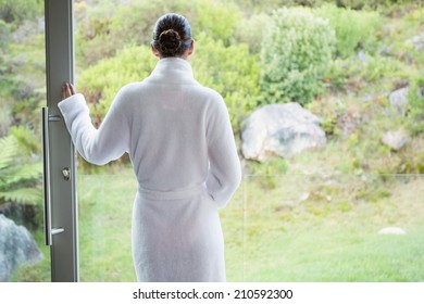 Rear View Of A Young Woman Wearing A Bathrobe