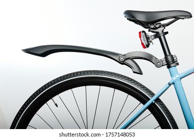 Rear wheel of bicycle  with seat isolated on grey background