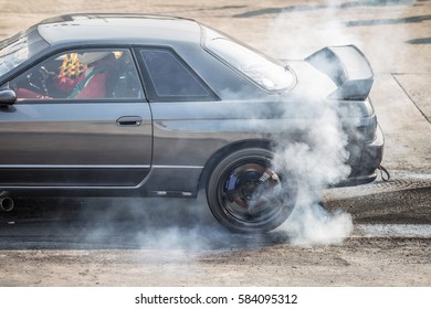 Rear Wheel Drive Sport Car Burning Tire For Warm Up Before Competition Start To Increase Type Temperature For Good Traction.