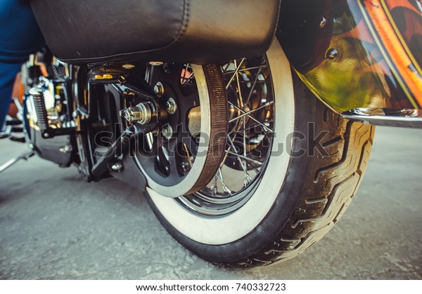 rear\
wheel of motorcycle with belt transmission\
rotation.