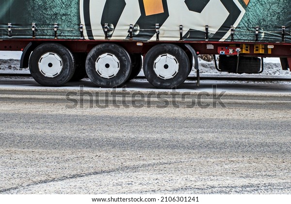 Rear wheels of\
a truck on a winter day\
close-up