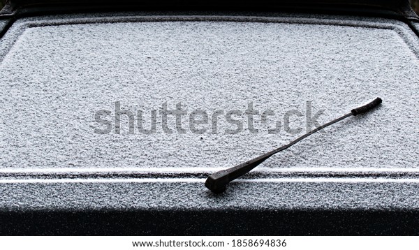 rear window wiper of an old car without a\
brush on a background of frozen\
snow