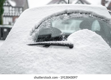 Rear Windscreen Wiper Cleaning Snow From Heated Back Window Of Small Car Windscreen On Fresh Icy Day Early Morning Powder Frozen Deep Snowfall Parked On House Driveway