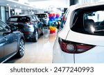 Rearview car parked in luxury showroom. Car dealership office. New car parked in modern showroom. Car for sale and rent business concept. Automobile leasing and insurance concept. Electric automobile.