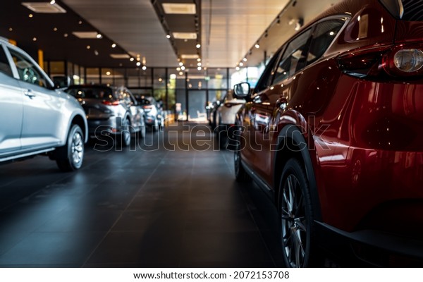 Rearview car parked in luxury showroom. Car\
dealership office. New car parked in modern showroom. Car for sale\
and rent business concept. Automobile leasing and insurance\
concept. Electric\
automobile.