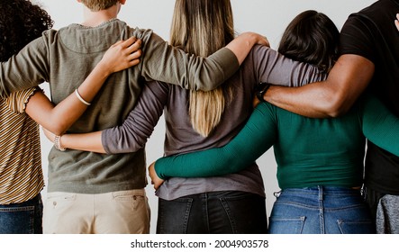 Rearview Of Diverse People Hugging Each Other