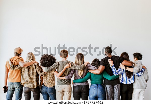 Rearview of diverse\
people hugging each\
other