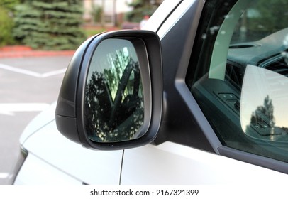 Rear-view mirror on a cargo van. Rearview mirror with reflection in it. Rear view mirror cargo van on the road. Wing mirror of a cargo van with nature street. - Shutterstock ID 2167321399