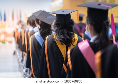 Rearview of the university graduates line up for degree award in university graduation ceremony. The university graduates are gathering in the university graduation ceremony. The crowd of the graduate - Shutterstock ID 1885769983