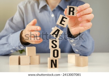 REASONS word written on wood abc block at wooden background.