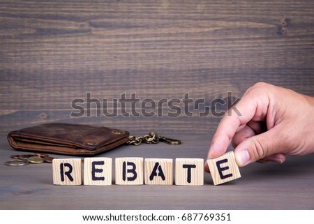 Rebate. Wooden letters on dark background