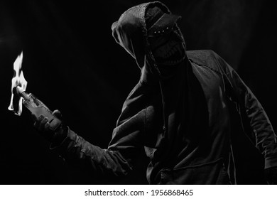 Rebel with molotov cocktail posing over dark background - Shutterstock ID 1956868465
