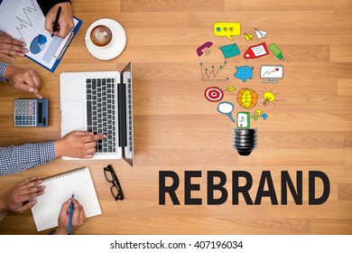 REBRAND Change Identity Branding Business team hands at work with financial reports and a laptop - Shutterstock ID 407196034