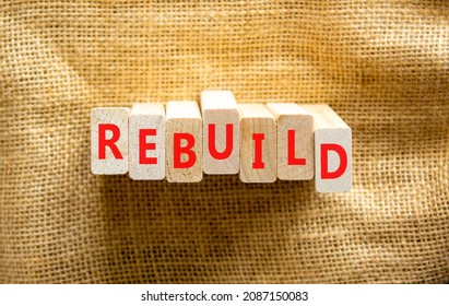 Rebuild And Build Symbol. The Concept Word Rebuild On Wooden Blocks. Beautiful Canvas Background, Copy Space. Business Rebuild And Build Concept.