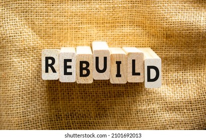 Rebuild And Build Symbol. The Concept Word Rebuild On Wooden Blocks. Beautiful Canvas Background, Copy Space. Business Rebuild And Build Concept.