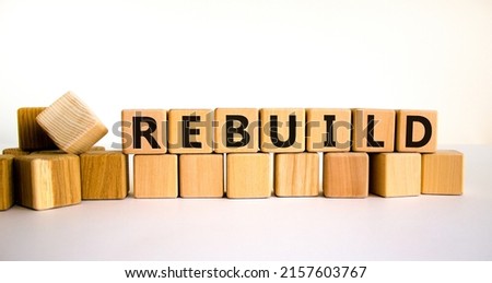 Rebuild and build symbol. The concept word Rebuild on wooden cubes. Beautiful white table, white background, copy space. Business rebuild and build concept. Stockfoto © 