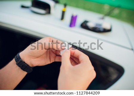 Rebuildable dripping atomizer or RDA for vaping or e-cigarette with Alien Clapton coil and cotton stripes wetted with e-liquid, modern vape device for quit smoking, macro photo with selective focus