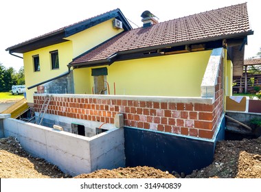 Rebuilding A Family House And Adding An Extension. Setting Up A Construction Site With Formwork. Digging The Brick Foundation For Hydro Isolation Of Basement.