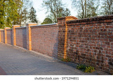 rebuilt old brick wall, combination of old and new fence, antique classic brick fence